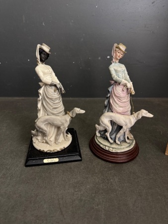 A Belcari Statue Lady with Dog & Unmarked Lady with Dog Statue