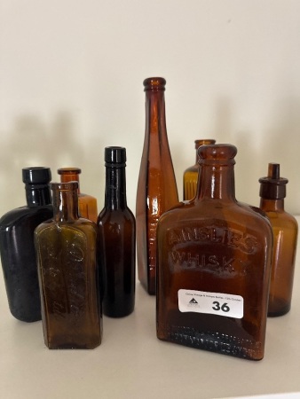 Selection of Amber Glass Bottles inc. Ainslies Whisky, Pioneer & Damdrine