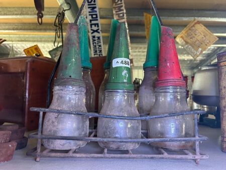 Rack of 6 oil bottles (3 bottles with tin tops)