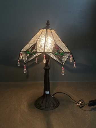 Tiffany style table lamp with a multi-panelled, geometric shade and crystals