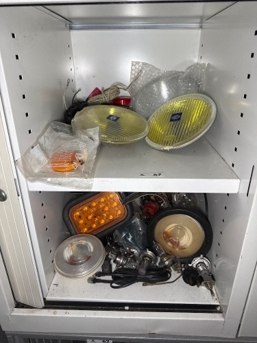 Two shelves of automotive lighting, etc