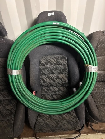 Roll of green hose possibly pneumatic