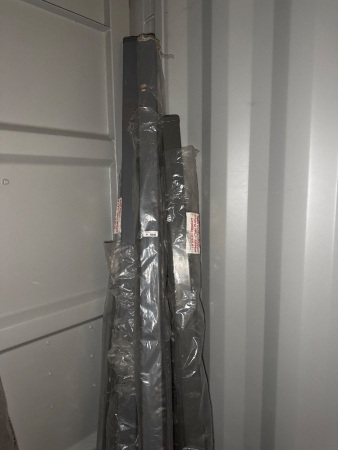 Quantity of grey powder coated steel poles with bottom plates