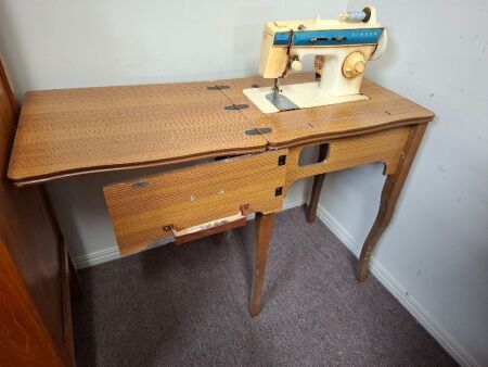 Electric SINGER sewing machine in cabinet