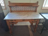 Vintage washstand with stone top and tiled splash