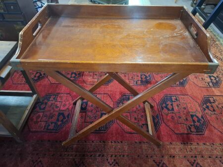 Vintage wooden serving tray on folding legs