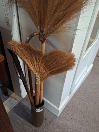 Brass shell casing with 2 brooms and 2 walking sticks
