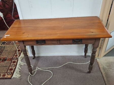 Vintage pine writing desk on turned legs and casters