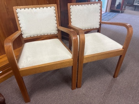 Pair of Parker style wooden armchairs with cream fabric upholstery