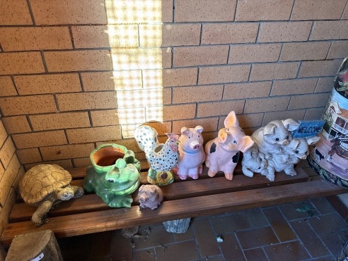 Shelf lot of ceramic, cement, and plastic figurines