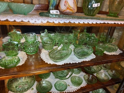 Shelf lot of green depression glass