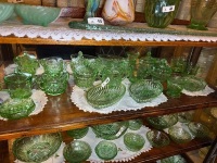 Shelf lot of green depression glass