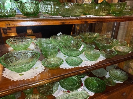 Shelf lot of green depression glass