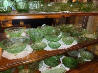 Shelf lot of green depression glass