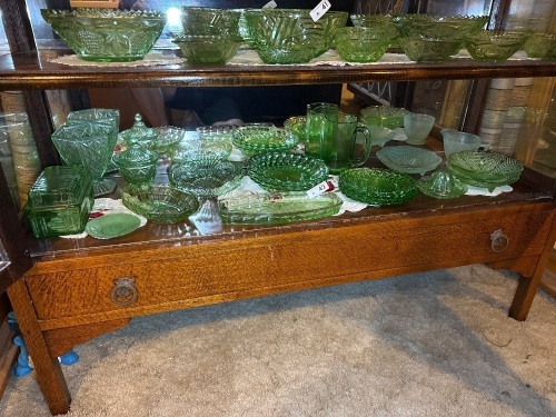 Shelf lot of green depression glass