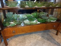 Shelf lot of green depression glass