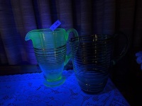 2x green glass pitchers with gold trim - one is glow/uranium