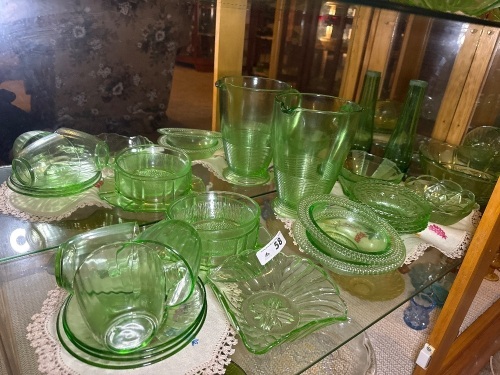 Shelf lot of green depression glass
