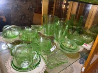 Shelf lot of green depression glass