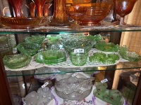 Shelf lot of green depression glassware