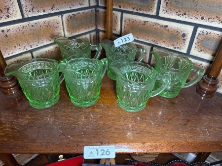 Assortment of green depression, glass cream pourers