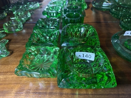 Assortment of green depression glass ashtrays