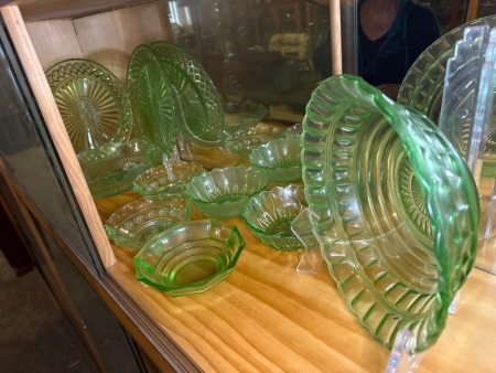Shelf lot of green depression glass