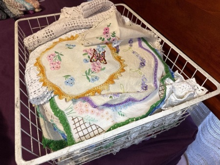 Crate of doilies &ndash; mostly embroidered