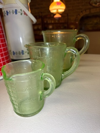 3 green glass measuring jugs