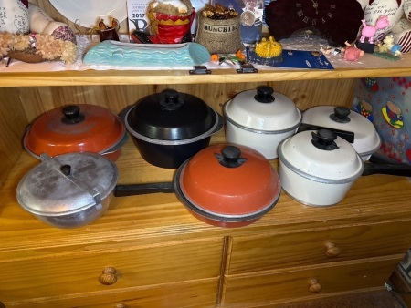 Shelf lot of heavy cast alloy saucepans etc