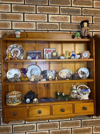 Assorted items on wall hanging shelves