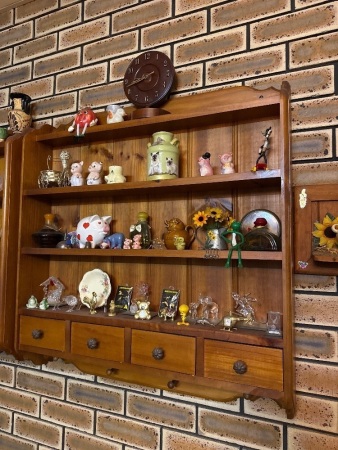 Assorted items on wall hanging shelves