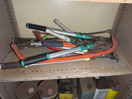 Shelf lot of pruning shears and saws, etc