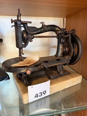 Unmarked sewing machine on marble base