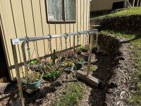 2 stainless steel stands with plants/baskets/pots