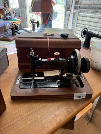 Frister and Rossman hand cranked sewing machine with case