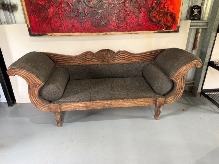 Vintage double-ended wooden sofa featuring carved scroll arms, and fabric upholstery
