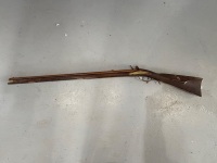 Antique Warrenter flintlock rifle with incised brass decorative fittings on the butt