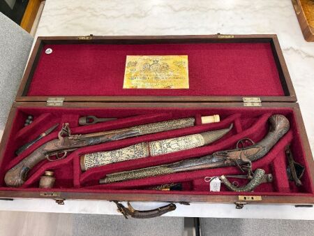 Antique flintlock/miquelet style pistols and matching dagger and sheath in felt lined wooden case