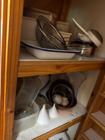 Four shelves of assorted kitchen items, mostly plastic storage containers