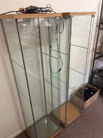 Pair of tall glass display cabinets with integrated lighting
