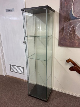 Tall glass display cabinet with dark top and base