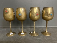 Four brass goblets griffin mounts coloured stones