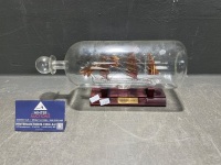 HMS Discovery ship in bottle on stand