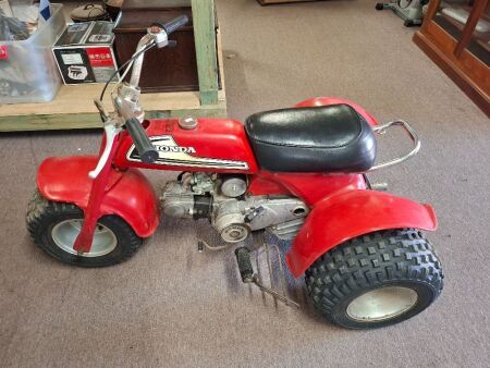 Vintage red Honda ATC70 three-wheeler all-terrain vehicle