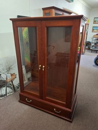 Mahogany display cabinet with double glass doors and lower drawers