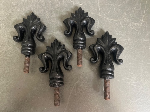 Four cast iron fleur de lis spike finials