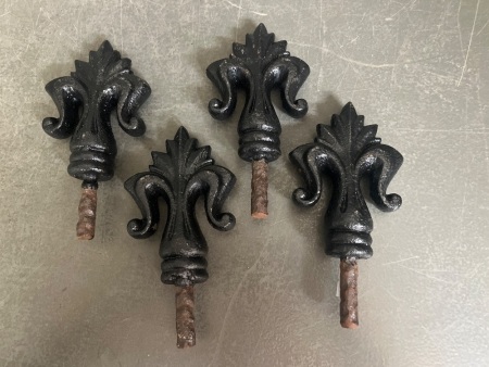 Four cast iron fleur de lis spike finials