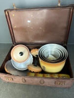 Aluminium picnic bowls cups and lidded jars in suitcase