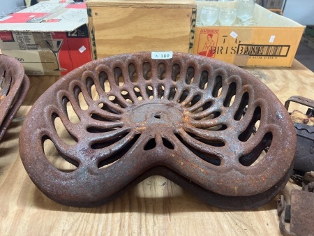 two antique cast iron fram tractor seat
